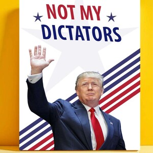 May include: A poster with the words "NOT MY DICTATORS" in red and blue, with a white star and stripes design. The image shows a man in a blue suit and red tie, raising his hand.
