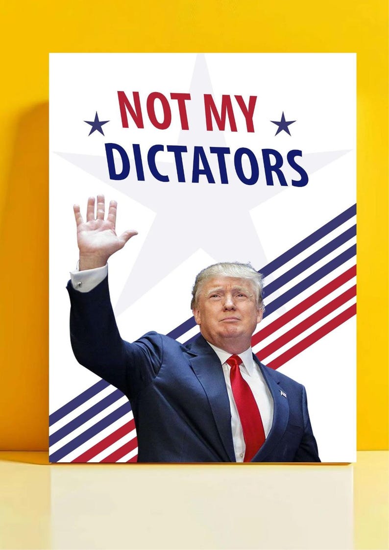 May include: A poster with the words "NOT MY DICTATORS" in red and blue, with a white star and stripes design. The image shows a man in a blue suit and red tie, raising his hand.