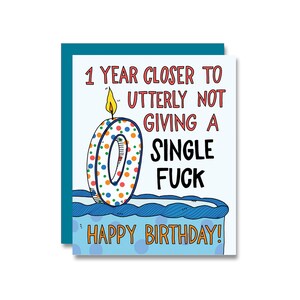 May include: A birthday card with a teal border features the text "1 YEAR CLOSER TO UTTERLY NOT GIVING A SINGLE FUCK" above a cake with a candle. The candle is shaped like a zero with colorful polka dots. The words "HAPPY BIRTHDAY!" are at the bottom.