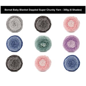 May include: Bernat Baby Blanket Dappled Super Chunky Yarn - 300g (6 Shades). Nine round skeins of super chunky yarn arranged in a grid, featuring variegated color patterns in shades of gray, blue, green, pink, and purple with textured fibers.