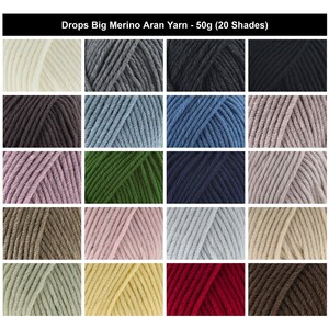 May include: A grid of 20 skeins of Drops Big Merino Aran yarn, each weighing 50g. The collection displays a variety of colours including white, grey, black, blue, green, pink, brown, and red, all featuring a twisted, multi-ply texture.