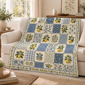 May include: A quilted throw blanket featuring a patchwork design of alternating squares. The pattern includes illustrations of yellow lemons with green leaves and white blossoms, blue floral prints, and light blue and white gingham check squares.