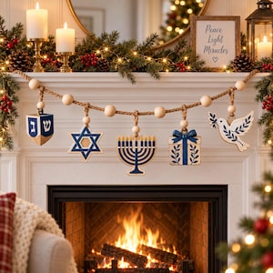May include: A decorative garland featuring a thick jute rope strung with natural wooden beads and five hanging wooden ornaments: a blue and white dreidel with Hebrew letters, a Star of David, a menorah, a gift box, and a white dove.