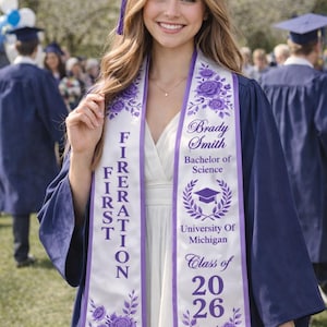 A smiling young woman in a graduation gown and cap stands in front of a crowd, holding a diploma.
