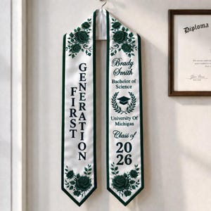 A graduation gown with the text "GENERATION" and "Brady Smith Bachelors of Science" printed on it, hanging on a wall.