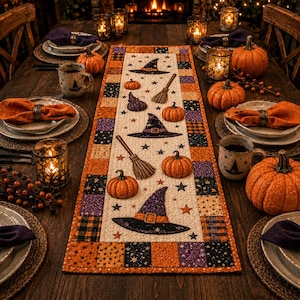 May include: A rectangular quilted table runner featuring a central cream panel with printed witch hats, brooms, and pumpkins, surrounded by a border of orange, purple, and black checkered squares with star patterns, set on a wooden dining table.