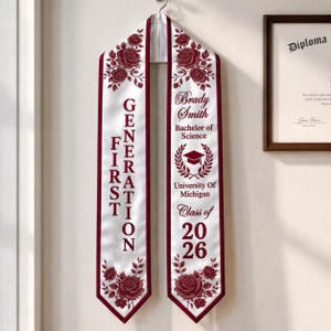 A graduation cap and gown with the text "Brady Smith Bachelors of Science" and "Class of 2026" printed on it, hanging on a wall.