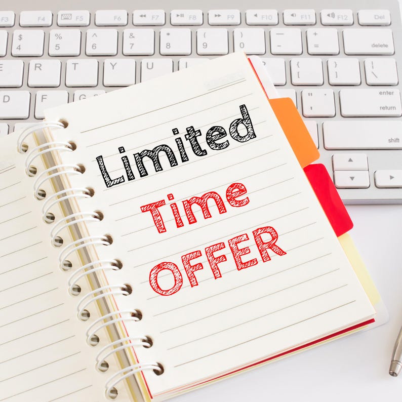 May include: A white notebook with a black spiral binding. The notebook has lined pages and a red and orange sticky note. The text "Limited Time Offer" is written in red on the notebook.