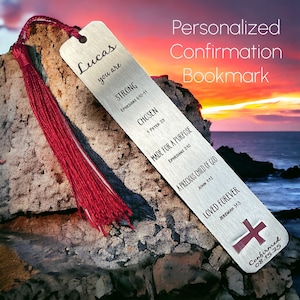 May include: Silver bookmark with a red tassel, featuring the name "Lucas" and inspirational quotes with bible verses. The bookmark is on a rock with a sunset background.
