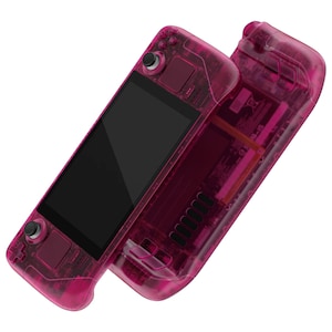May include: A pink handheld gaming console with a transparent case. The console has a screen, buttons, and a joystick. The console is open, revealing the internal components.