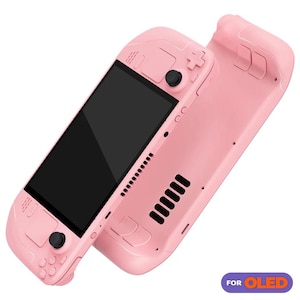 May include: A pink handheld gaming console with a large screen and buttons on the sides. The console is designed for OLED displays. The text "FOR OLED" is visible on the bottom right corner of the image.