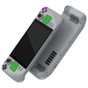 May include: A gray handheld gaming console with a black screen and green and purple buttons. The console has a textured back and a gray and black controller on the side.