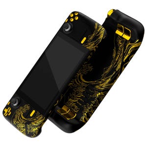 May include: A black handheld gaming console with gold accents and a wave design. The console has a screen, buttons, and a joystick.