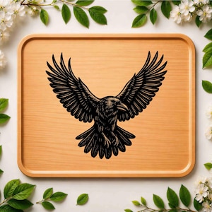 May include: A rectangular light brown wooden serving tray featuring a centered black graphic illustration of a raven with its wings spread wide in flight. The bird is depicted with detailed feather textures and a sharp beak facing to the right.