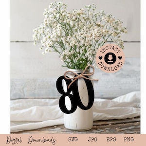 May include: Black and white number 80 cut out with a rustic twine bow. The number is in front of a white vase with white flowers. The image also includes a pink circle with the text "Instant Download" and a download icon.