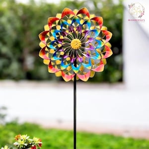 May include: A colourful metal wind spinner in the shape of a flower with red, yellow, blue, and purple petals. The spinner is mounted on a black metal stake.