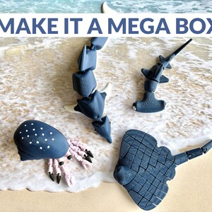 May include: Four articulated plastic sea creatures in blue and white. A hammerhead shark, a stingray, an octopus, and a whale shark.  The text "MAKE IT A MEGA BOX" is at the top of the image.