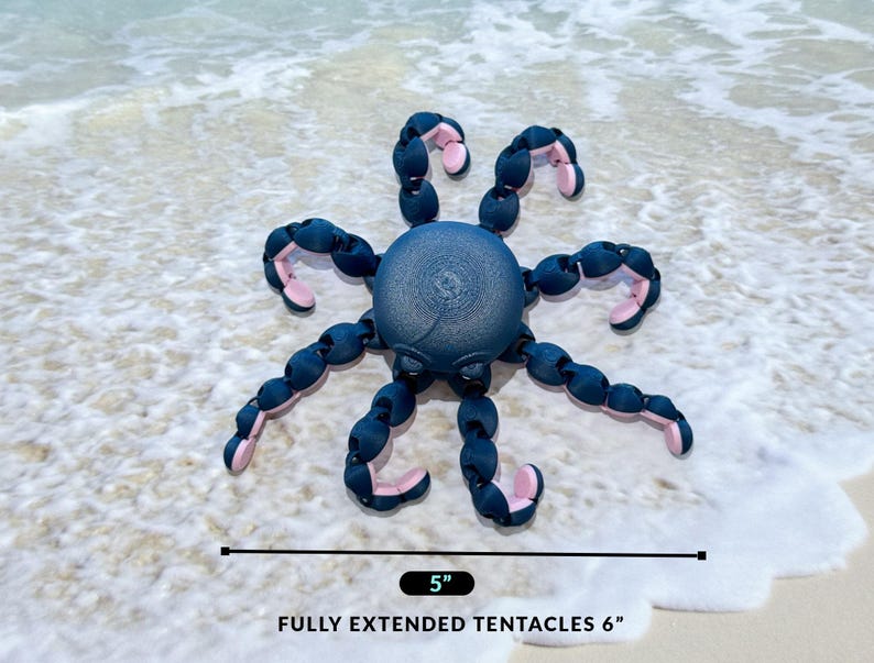 May include: A blue and pink octopus-shaped toy with flexible tentacles. The toy is 5 inches wide and has tentacles that extend to 6 inches long. The toy is on a sandy beach.