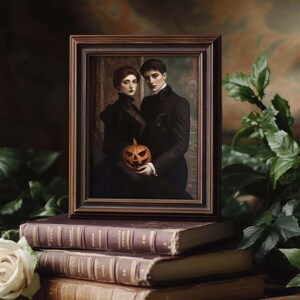May include: A framed portrait of a couple in dark attire, one holding a carved pumpkin, rests on antique books. The portrait has a dark wooden frame. White roses and green foliage surround the books, creating a gothic, Halloween theme.