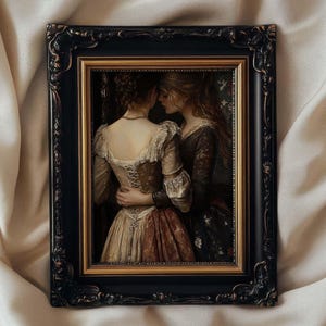 May include: A framed artwork featuring two women in period clothing embracing. The painting has a warm color palette with gold, brown, and cream tones. The ornate black frame adds a touch of elegance to the artwork.