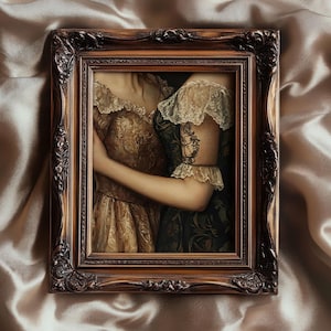 May include: A framed painting featuring two figures in ornate, vintage gowns. The artwork is set within a detailed, brown wooden frame. The gowns are in shades of gold and dark green, with lace detailing. The painting is set against a satin background.