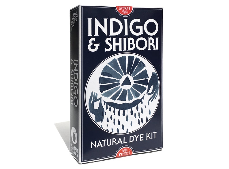 Graham Keegan's Indigo and Shibori Natural Dye Kit sits on a white background. This box, the size of a hardcover novel contains all the ingredients and how-to instructions for you to DIY an Indigo project including fun and easy folding patterns.
