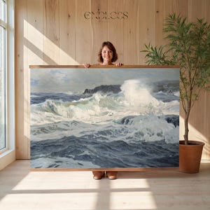 May include: A framed artwork depicting a seascape with crashing waves in shades of blue, gray, and white. The artwork is held by a person and has a wooden frame. The word "ENDLESS" is above the artwork.