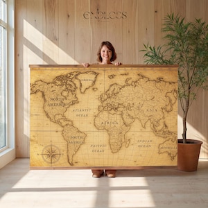 May include: A large rectangular world map wall hanging with a vintage aesthetic, featuring a sepia-toned parchment background, black outlines of continents, labeled oceans, and a compass rose in the bottom left corner, framed by wooden rails.