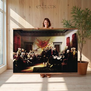 May include: A large rectangular wall hanging featuring a reproduction of the Declaration of Independence painting, depicting a group of men in 18th-century attire gathered in a room with red curtains and a central flag, held by wooden rails.