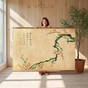 May include: A large rectangular wall hanging featuring a beige background with a dark green tree branch extending from the right side, adorned with small pink blossoms. Black Chinese calligraphy and a red square seal are printed on the left side.