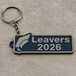 May include: A navy blue and gray keychain with the text "Leavers 2026" and a graduation cap graphic. The keychain has a silver metal ring and chain.