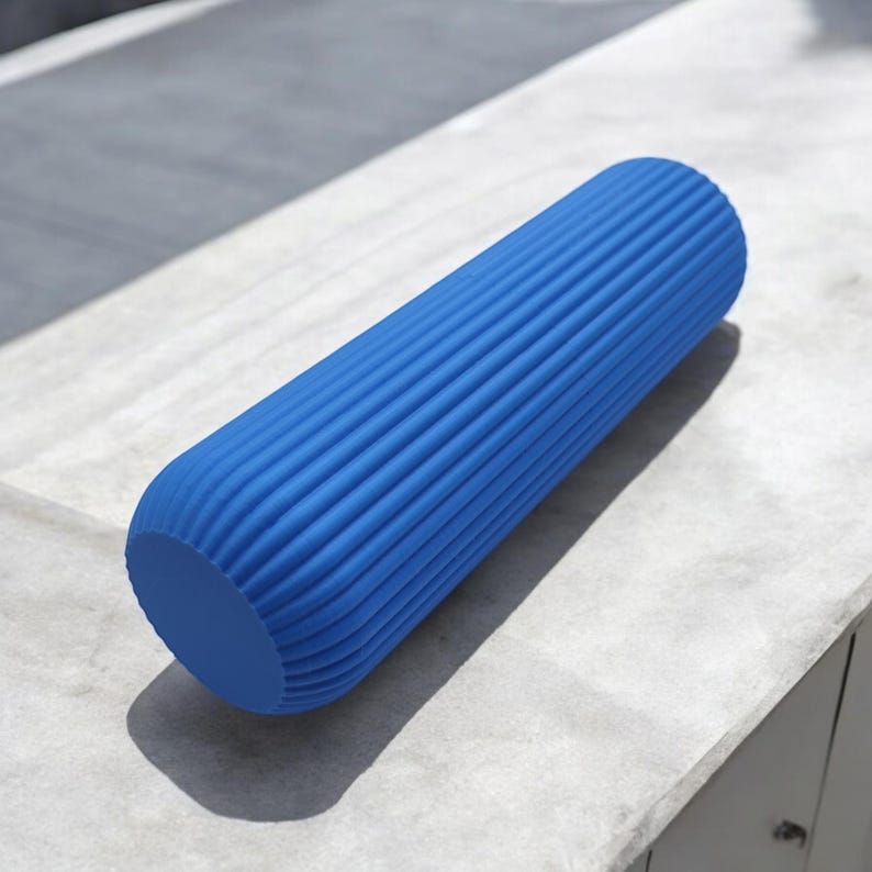 May include: A blue foam roller with a ridged surface. The cylindrical fitness tool is designed for muscle recovery and self-massage. The roller is made of a durable material and is suitable for various exercises.