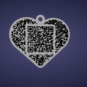 May include: A heart-shaped pendant with a QR code pattern. The pendant is light gray and has a small hole at the top for attaching to a chain or keyring. The background is a solid dark blue.