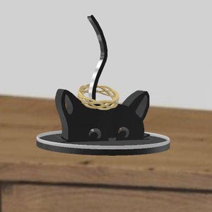 May include: A white ceramic mug with a black handle and the text "But First, Coffee" in a black, bold font. The mug is on a white surface. The mug is likely for hot beverages.