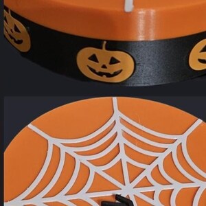 May include: A circular, orange Halloween decoration featuring a white spiderweb and a black spider. The base is black with jack-o'-lanterns. Ideal for seasonal home decor.