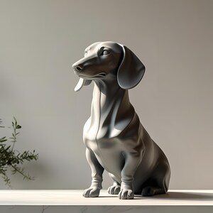 May include: A gray dachshund sculpture in a seated position. The dog has long ears and a long body, with its head turned to the left. The sculpture is on a white surface, with a light gray background.