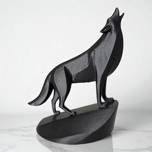 May include: A black, geometric wolf sculpture in a howling pose. The wolf stands on a textured, angled base. The sculpture is made of a matte black material and is set against a white background.
