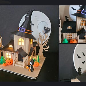 May include: A wooden Halloween-themed house with a witch's hat, pumpkins, and a full moon backdrop. The house has lit windows and a small figure of a witch. Bats and a ghost are also featured in the design. The overall color scheme is black, orange, and beige.