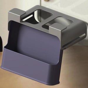 May include: A gray metal and purple plastic organizer designed to hang on a door or cabinet. The organizer has a rectangular purple bin and a gray top section with two compartments.