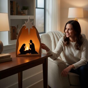May include: A wooden nativity scene with an internal light, showing silhouettes of Mary, Joseph, and baby Jesus. A star sits atop the arched frame. The warm glow creates a cosy, inviting atmosphere, ideal for festive decoration.
