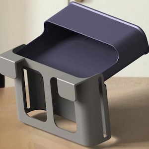 May include: A modern, two-tone desk organizer. The top section is a dark purple, while the base and sides are a light gray. The organizer has a tray-like top and a rectangular base with cut-out sections.