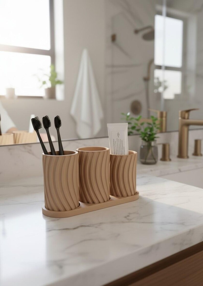 May include: A wooden bathroom organizer with three cylindrical holders. The holders have a ridged design and are arranged on a rectangular base. Three black toothbrushes and a tube of toothpaste are visible.
