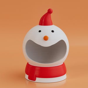 May include: A novelty snowman-shaped container, featuring a red hat and scarf. The white body has black eyes and an orange nose. The container has a large opening, ideal for storage or display. A festive item for seasonal decor.
