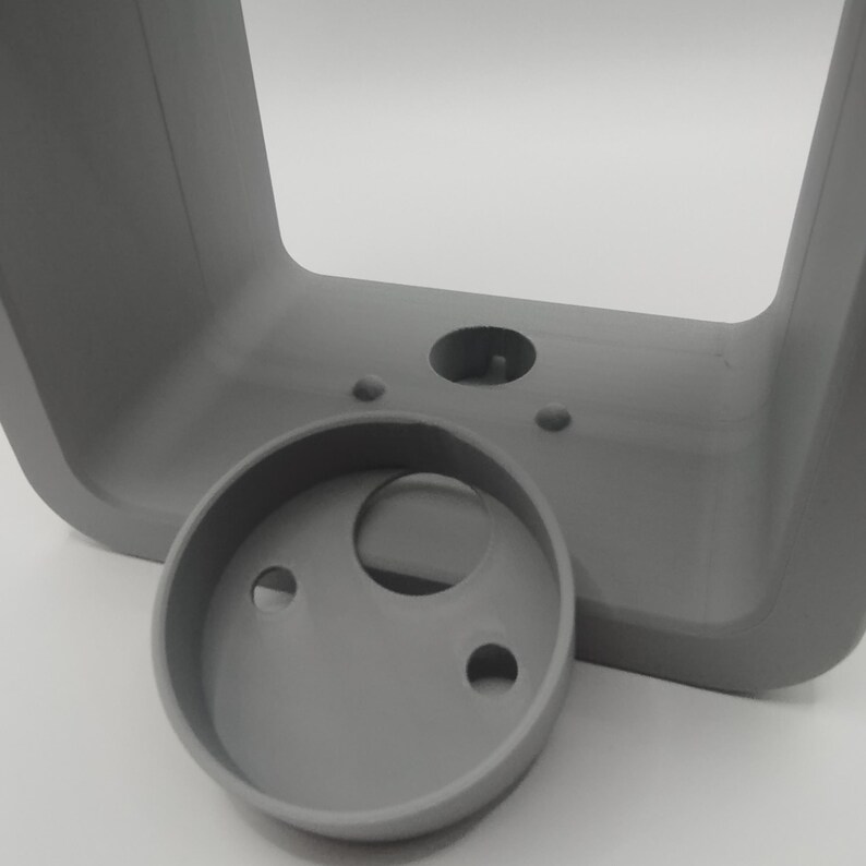 May include: A set of three ceramic mugs with a speckled, matte finish. The mugs are in shades of cream, light gray, and dark gray. Each mug has a simple, minimalist design, perfect for coffee or tea.