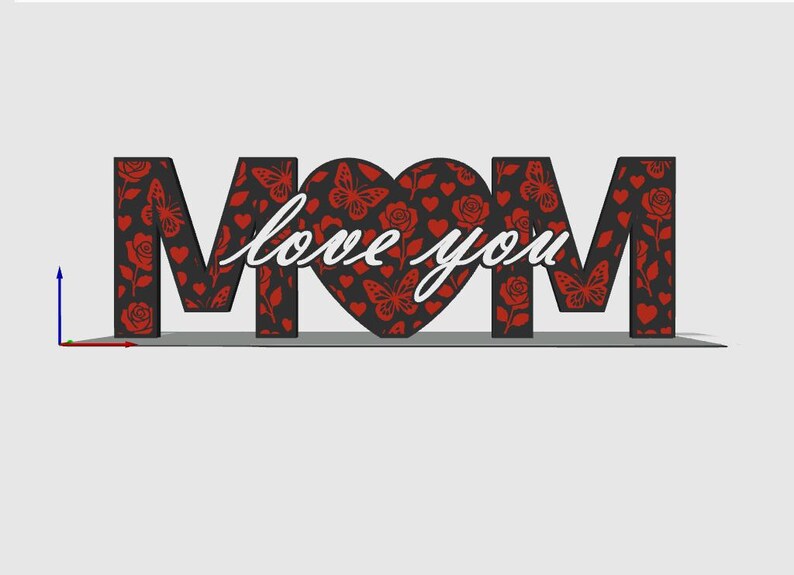 May include: A decorative sign spelling "MOM" with the words "love you" in cursive. The letters are black with a red floral and butterfly pattern. The heart-shaped "O" is also patterned. A thoughtful gift.