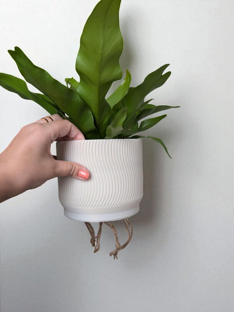 May include: A set of three ceramic mugs with a speckled, matte finish. The mugs are in shades of cream, light gray, and dark gray. Each mug has a simple, minimalist design, perfect for coffee or tea.