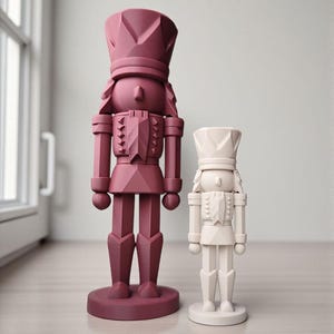 May include: Two decorative nutcrackers in a modern style. One is a deep burgundy color, and the other is off-white. Both have a geometric design and stand on a round base. The larger nutcracker is approximately 12 inches tall.