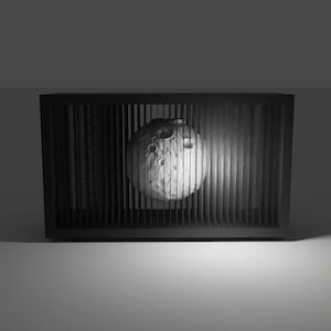 May include: A black rectangular frame with vertical slats, partially obscuring a spherical object resembling the moon. The moon-like sphere has a textured surface with craters and is lit from the right side.