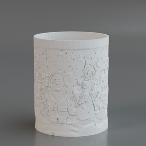 May include: A white cylindrical candle holder with embossed Christmas-themed designs. The designs include Santa Claus and a snowman, set against a snowy background. The candle holder is made of a solid, opaque material.