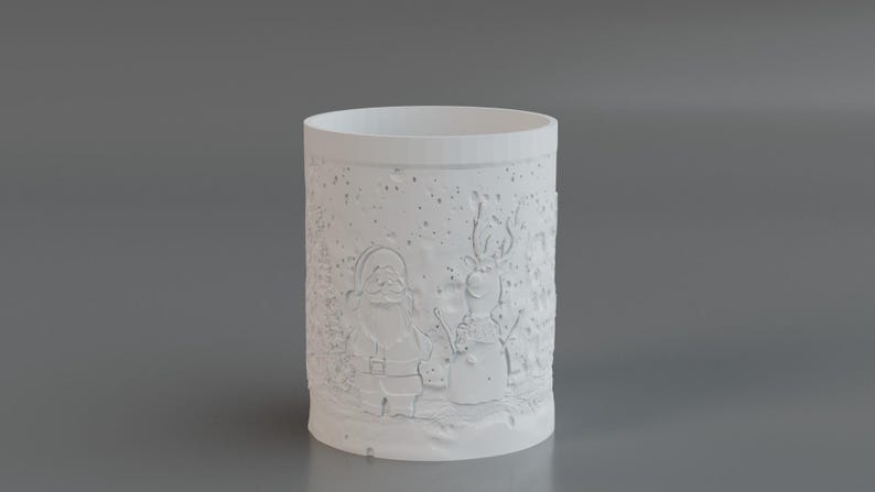 May include: A white cylindrical candle holder with embossed Christmas-themed designs. The designs include Santa Claus and a snowman, set against a snowy background. The candle holder is made of a solid, opaque material.
